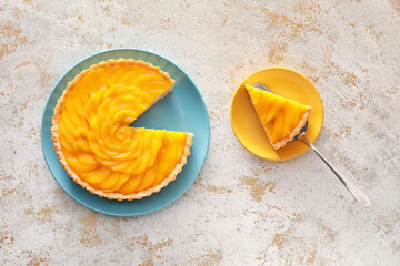 Fototapeta na wymiar Plates with tasty mango pie on light background