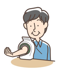 血圧を測定する男性　上腕式測定機