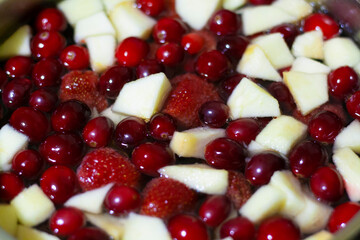 Compote of fresh berries and fruits, strawberries, cranberries and apples, background © Екатерина Хныкина
