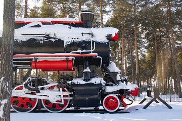 Steam locomotive in a pine forest on a dead-end branch. In a dead end there is a steam...