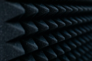 sound absorbing material on the wall close up as a dark geometric abstract background