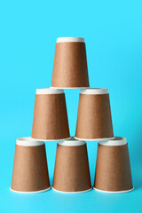 Blank takeaway cups on color background