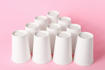 Blank takeaway cups on color background