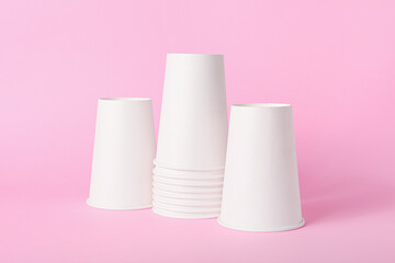 Blank takeaway cups on color background