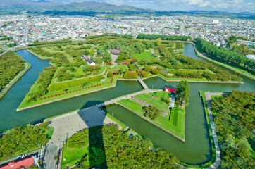 Outer moat of goryokaku park and goryokaku Tower in Hakodate, Hokkaido, Japan.