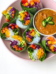 Spring rolls on a plate with a white background