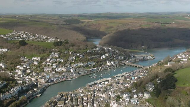 Stunning aerial landscape and cornish countryside vista shot of the town of Looe and the east west looe rivers convening on the outskirts