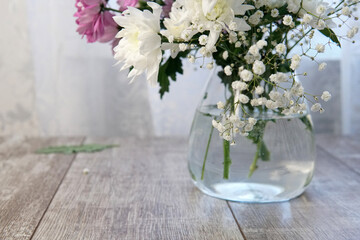 white and pink flowers in a vase  on the table