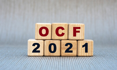 OCF 2021 - word on wooden cubes on a gray background