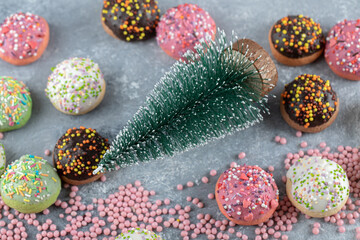 Cookies decorated with sprinkles around pine tree