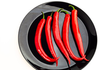 red hot chili pepper on the plate isolated on a white background