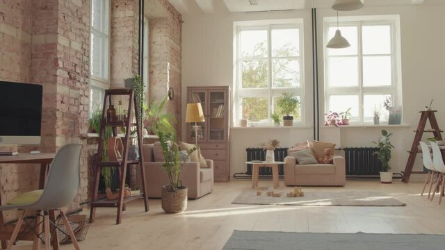 Tracking shot of interior of cozy living room with workspace and childrens toys on floor