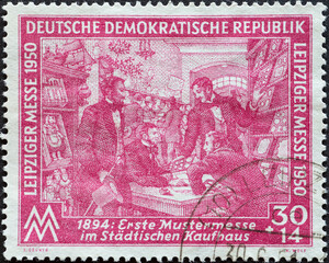 GERMANY, DDR - CIRCA 1950: a postage stamp from Germany, GDR showing a sales booth in the municipal department store for the first sample fair in 1894. Leipzig spring fair