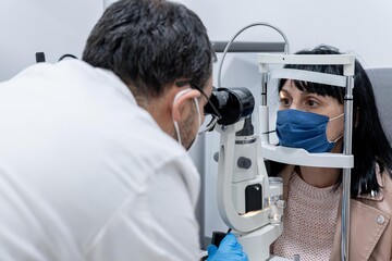Optician measuring a woman's eyesight