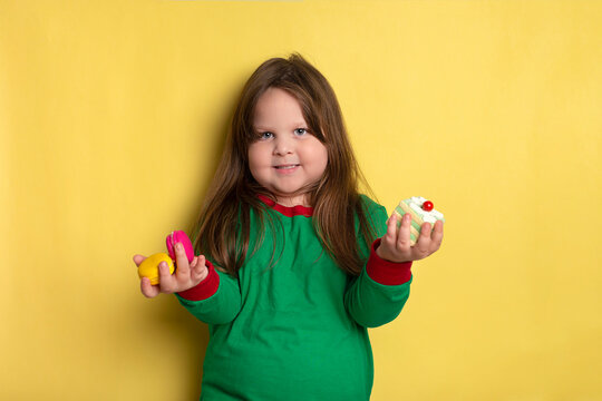 Cute little obese girl of 3-4 years who loves cakes