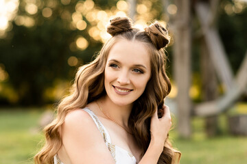 Beautiful girl with hair and makeup on the street on a sunny day