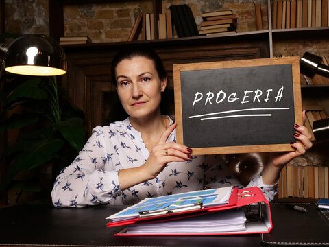 Financial concept about PROGERIA with phrase on black chalkboard.