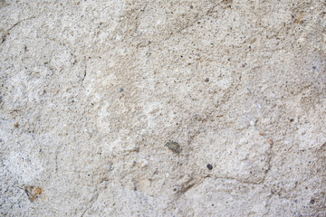 Vintage background texture concrete wall colored plaster. Stucco wall texture. Dense grain texture made with tiny stones, earthy colors, on a wall background. Backdrop dirty light gray cement wall.