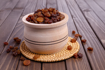 Dark raisins in a wooden dish