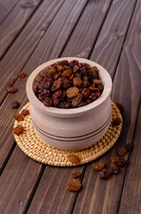 Dark raisins in a wooden dish