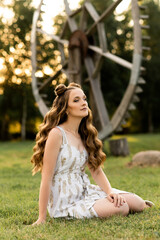 Naklejka premium Beautiful girl with hair and makeup on the street on a sunny day