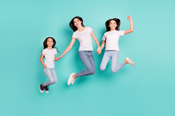 Fototapeta na wymiar Full length body size photo sisters jumping up wearing casual outfits happy overjoyed cheerful isolated vivid blue color background