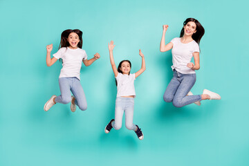 Full length body size photo funky cool sisters jumping up won lottery keeping hands up isolated vibrant blue color background