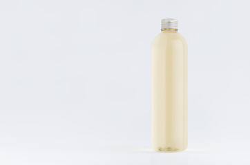 Transparent plastic tall thin bottle with pale fresh drink or cosmetic essential oil, silver cap mockup on white background.