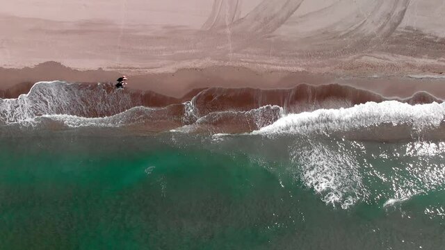 Aerial view directly above beach, Torrox, Malaga, Spain, slow motion wide shot