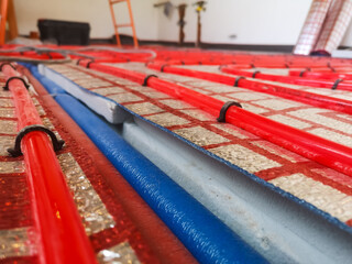 Cross-linked polyethylene heating pipes for underfloor heating on a heat-insulating material and polystyrene foam insulation on a concrete floor