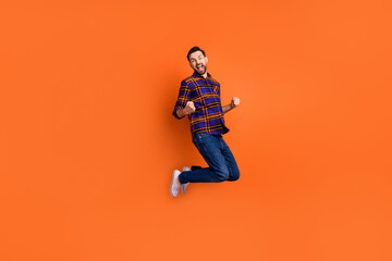 Fototapeta na wymiar Full body photo of astonished person fists up open mouth shout yes isolated on orange color background