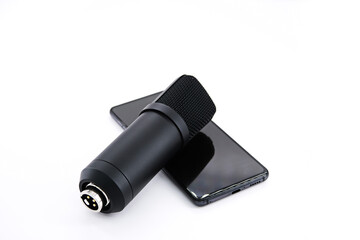 Concept for Clubhouse Drop-in audio is a voice-activated social media app. smartphone and microphone on a white background.