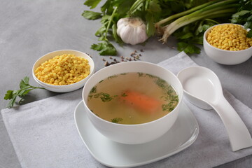 Chicken soup , chicken broth, with pieces of chicken and vegetables and shkedei marak an Israeli...