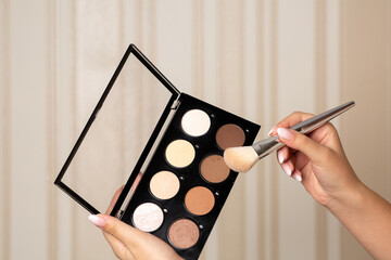 Woman using luxury eye shadow palette