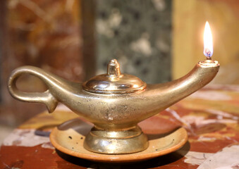 ancient oil lamp with flame to evoke the genie of the lamp