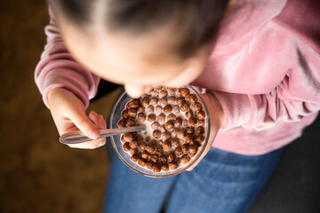 girl eating Chocolate Cereal