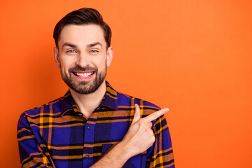 Photo of young cheerful man happy smile indicate finger empty space ad promo choice advise isolated...
