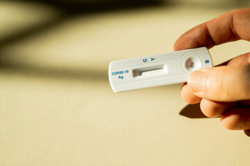 holding a covid-19 test in hand