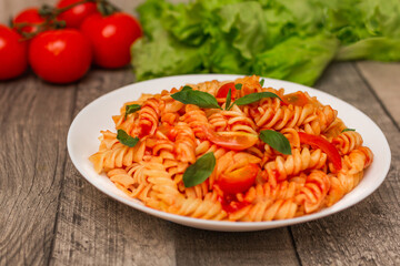Italian pasta on plate on grey wooden background 