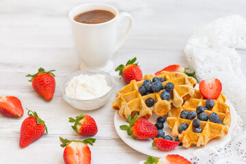 Homemade belgian waffles with  strawberries and blueberries. Delicious Breakfast with berries.