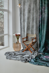 panoramic windows, minimalism in the interior. A vase of flowers on the table. Tactile background.