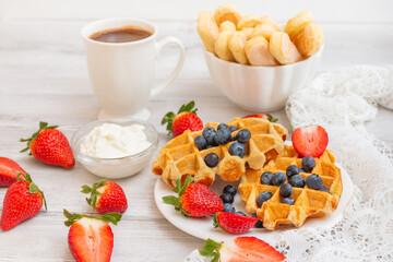 Homemade belgian waffles with  strawberries and blueberries. Delicious Breakfast with berries.