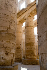 KARNAK TEMPLE - Massive columns inside beautiful Egyptian landmark with hieroglyphics, and ancient symbols. Famous landmark in the world near the Nile River and Luxor, Egypt