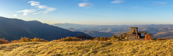 Panorama of a mountainous area with the ruins of a building. Autumn in the Carpathian mountains