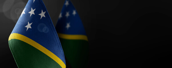 Small national flags of the Solomon Islands on a dark background