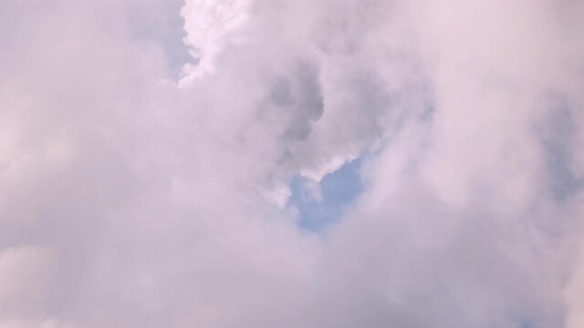 White clouds move quickly across the blue sky. The concept of dreams. Time laps
