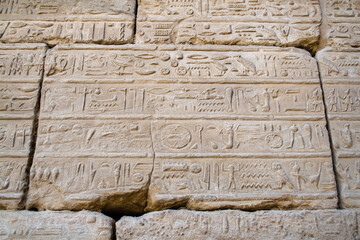 KARNAK TEMPLE - Massive columns inside beautiful Egyptian landmark with hieroglyphics, and ancient symbols. Famous landmark in the world near the Nile River and Luxor, Egypt