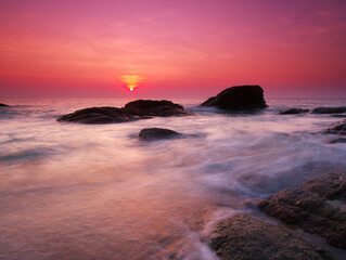 Fototapeta na wymiar Beautiful natural seascape wave hit the rock during sunrise
