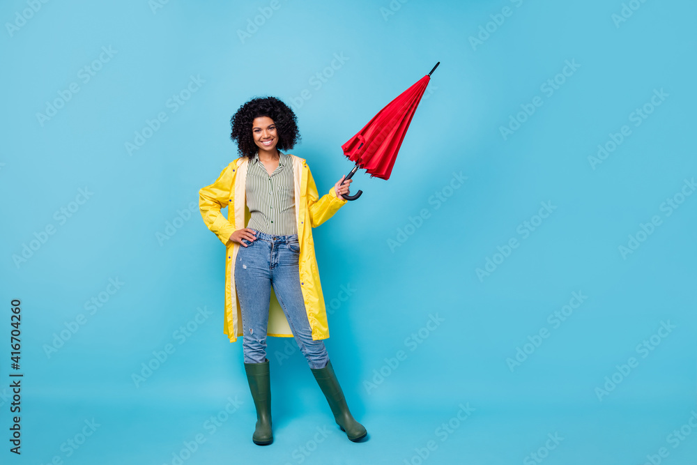 Sticker Full length photo of young cheerful woman happy smile wear raincoat umbrella isolated over blue color background