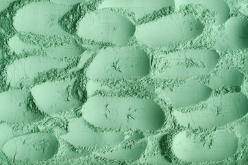 Green cosmetic clay powder (kelp facial mask, spirulina body wrap) texture close up, selective...